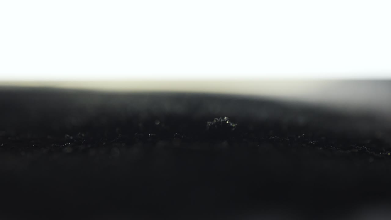 Black Volcanic Sand Macro Forming Abstract Magnetic Waves