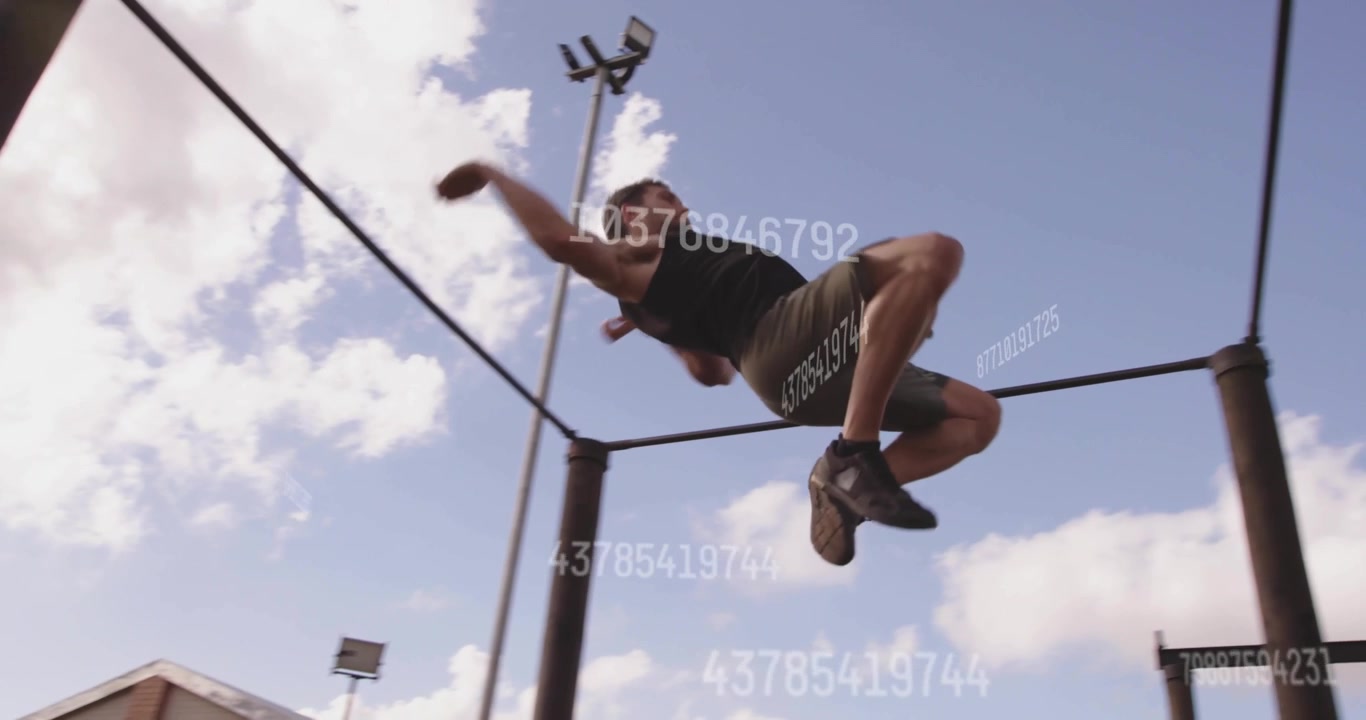 Male fitness athlete starting swinging on pull-up bar, backflipping and ascending rope for strength