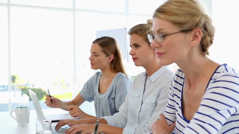 Businesswomen-listening-to-a-presentation