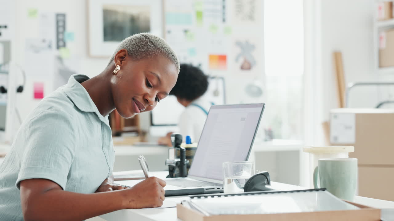 Black woman receptionist, writing notes