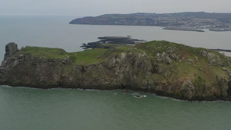 Reverse-tracking-shot,-Ireland's-eye-cliffside