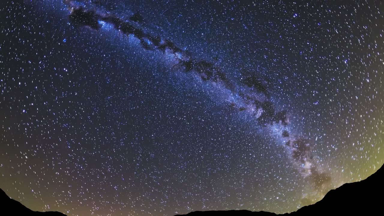 Wide-angle shot of a starry night sky with the Milky Way, capturing the vastness of the universe