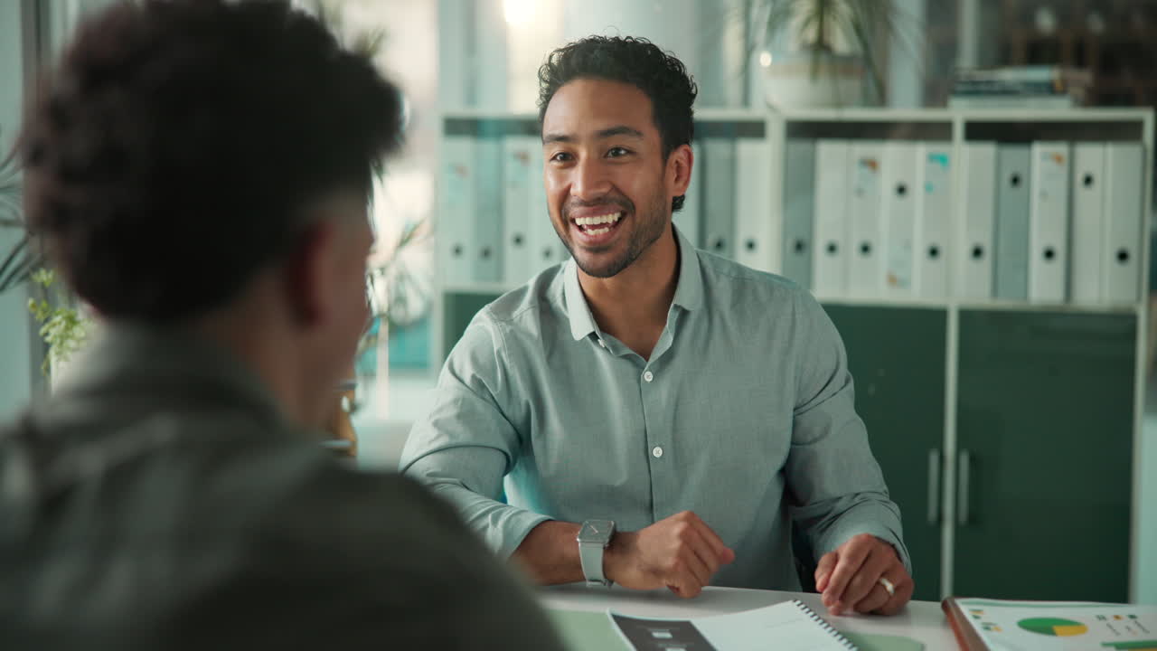 Smiling Businessman Shaking Hands with Colleague in Office
