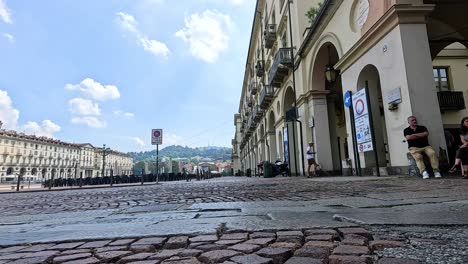 people and traffic signs on cobblestone street