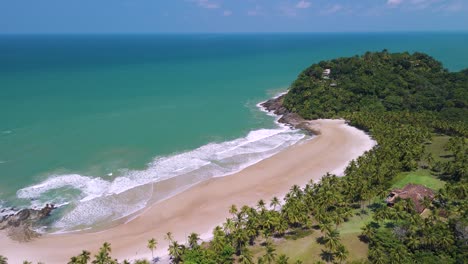 backward rotating aerial view of secluded tropical prainha beach on a beautiful, clear day