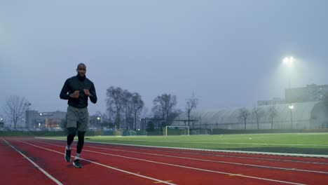 man running on a track at dawn
