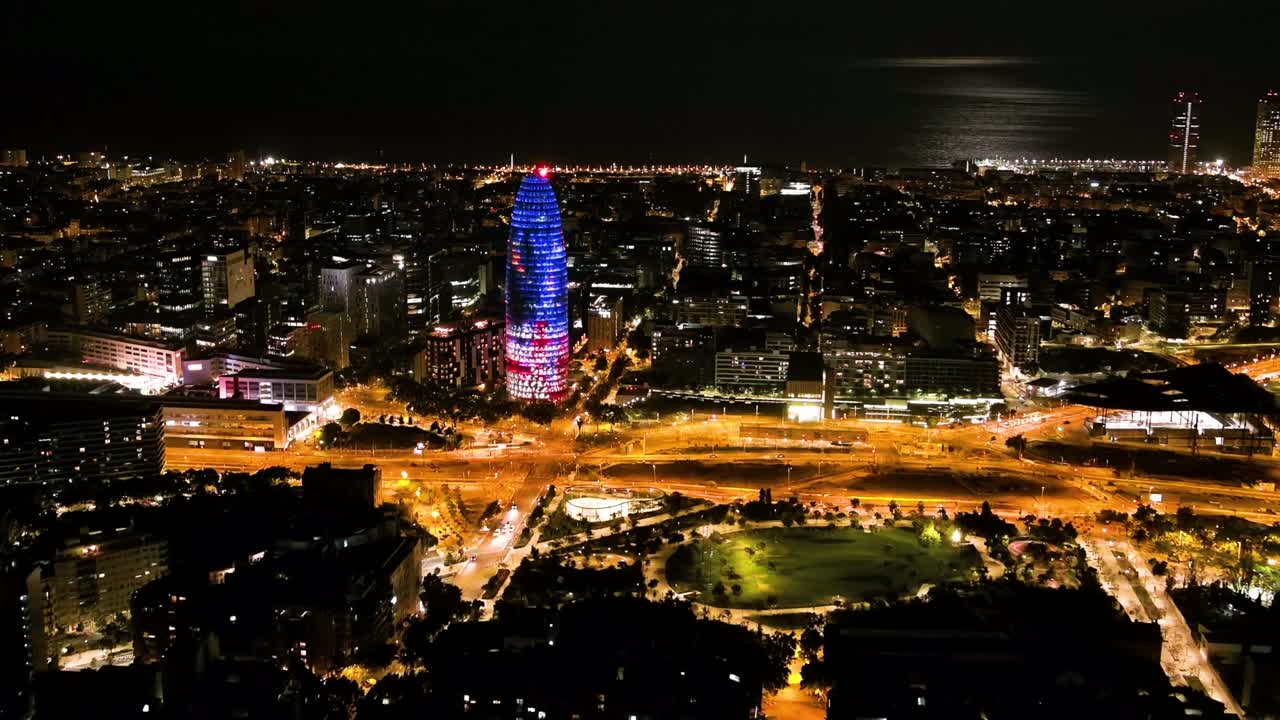 Barcelona skyline with modern office buildings at night, Catalonia, Spain. Aerial view of Torre Agbar (Torre Glòries)