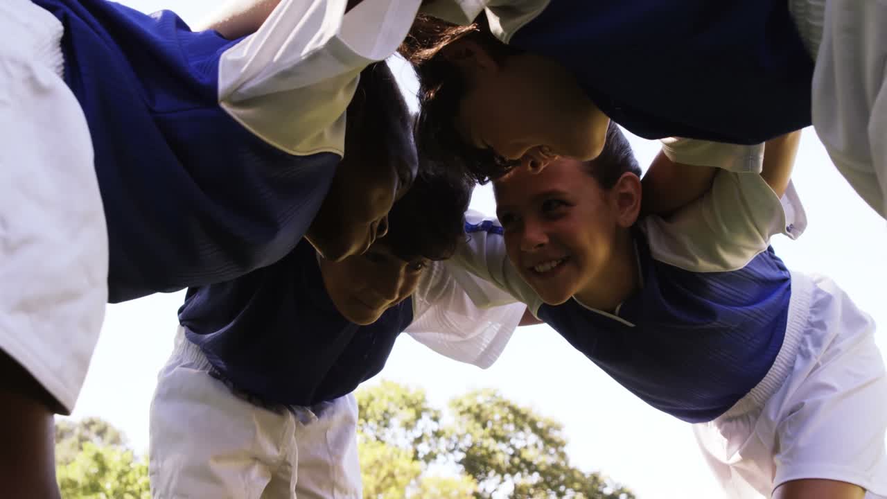 Kids forming a huddle in park