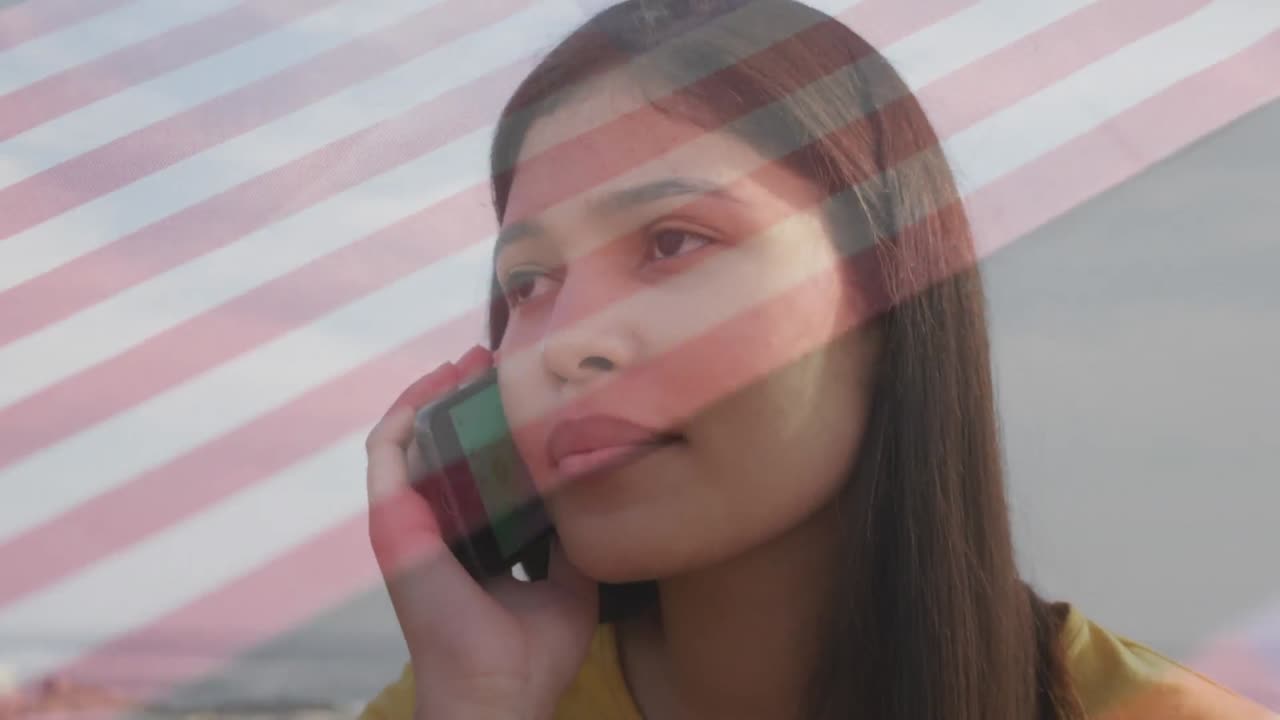 animación de la bandera de américa sobre un primer plano de una joven biracial hablando por teléfono celular