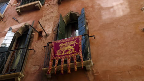 flag of the republic of venice hanging on the balcony in the old town of venice, italy