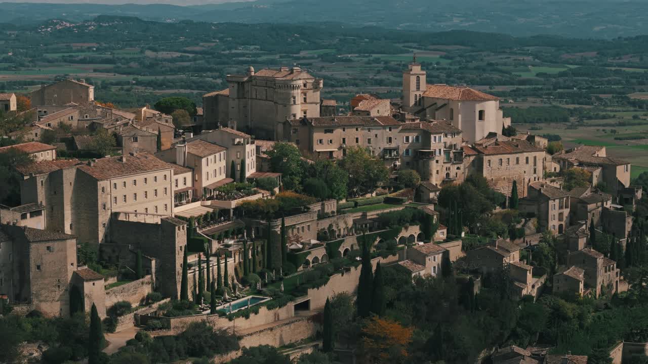 Retreating pan up of Gordes, Provence, France, with iconic village view and scenic countryside up on mountain top