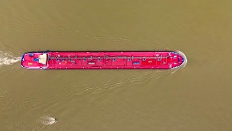 deck bridge of industrial barge tanker ship cruising up river rhine transporting cargo