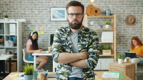 man with arms crossed in modern office