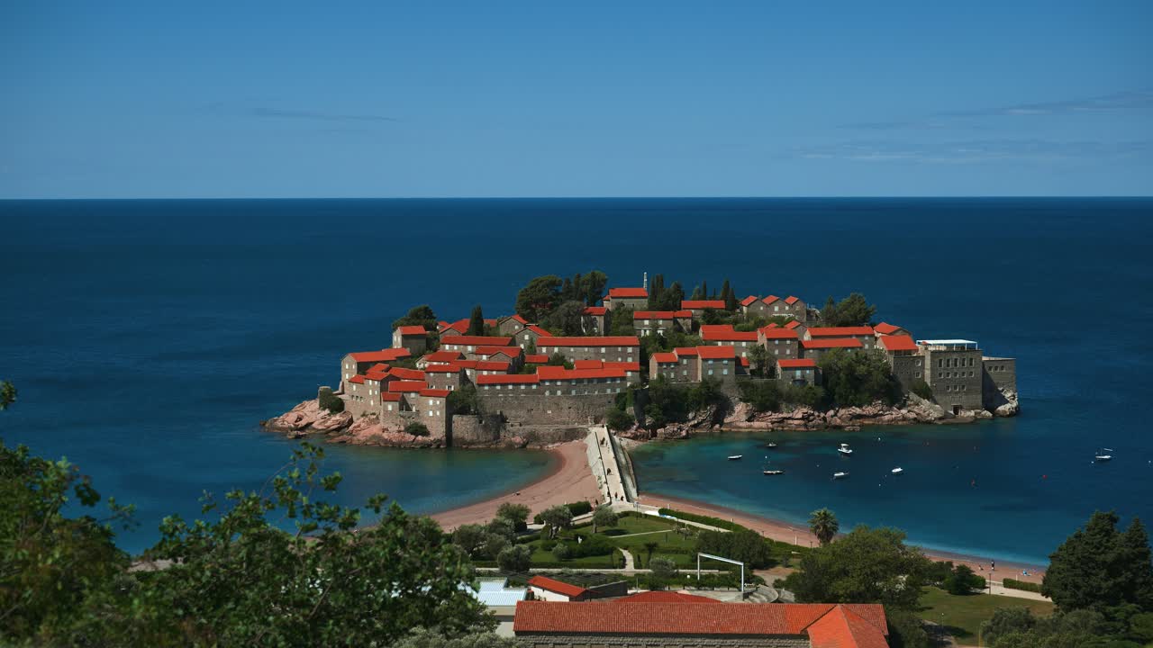 Scenic view of Sveti Stefan island in Montenegro surrounded by blue Adriatic Sea, seen from above