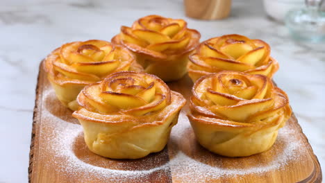 delicious apple rose tarts dusted with powdered sugar