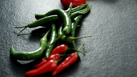 Various-chili-pepper-on-black-background-4k