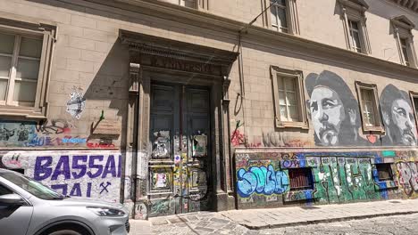 graffiti-covered walls with parked cars