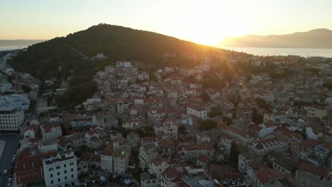 aerial view of split, croatia, during sunset, showcasing the beautiful coastline with dense urban buildings built up at golden hour