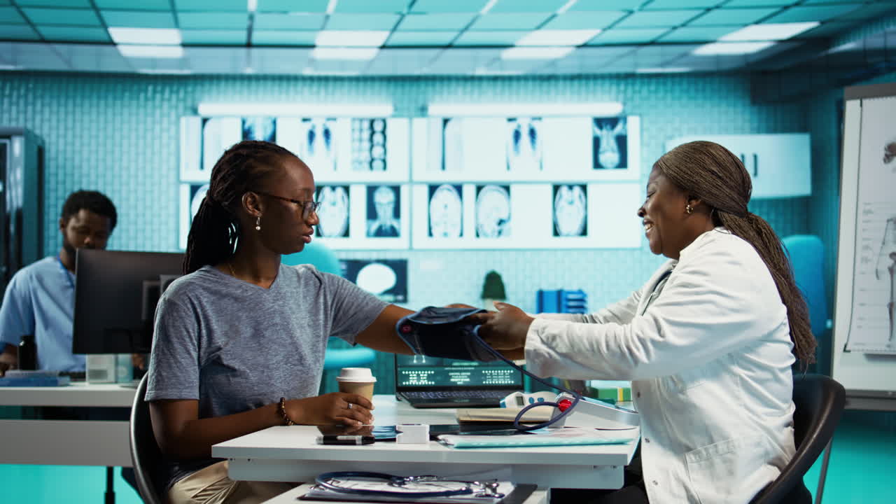 Black medic practitioner takes blood pressure with a blood pressure monitor