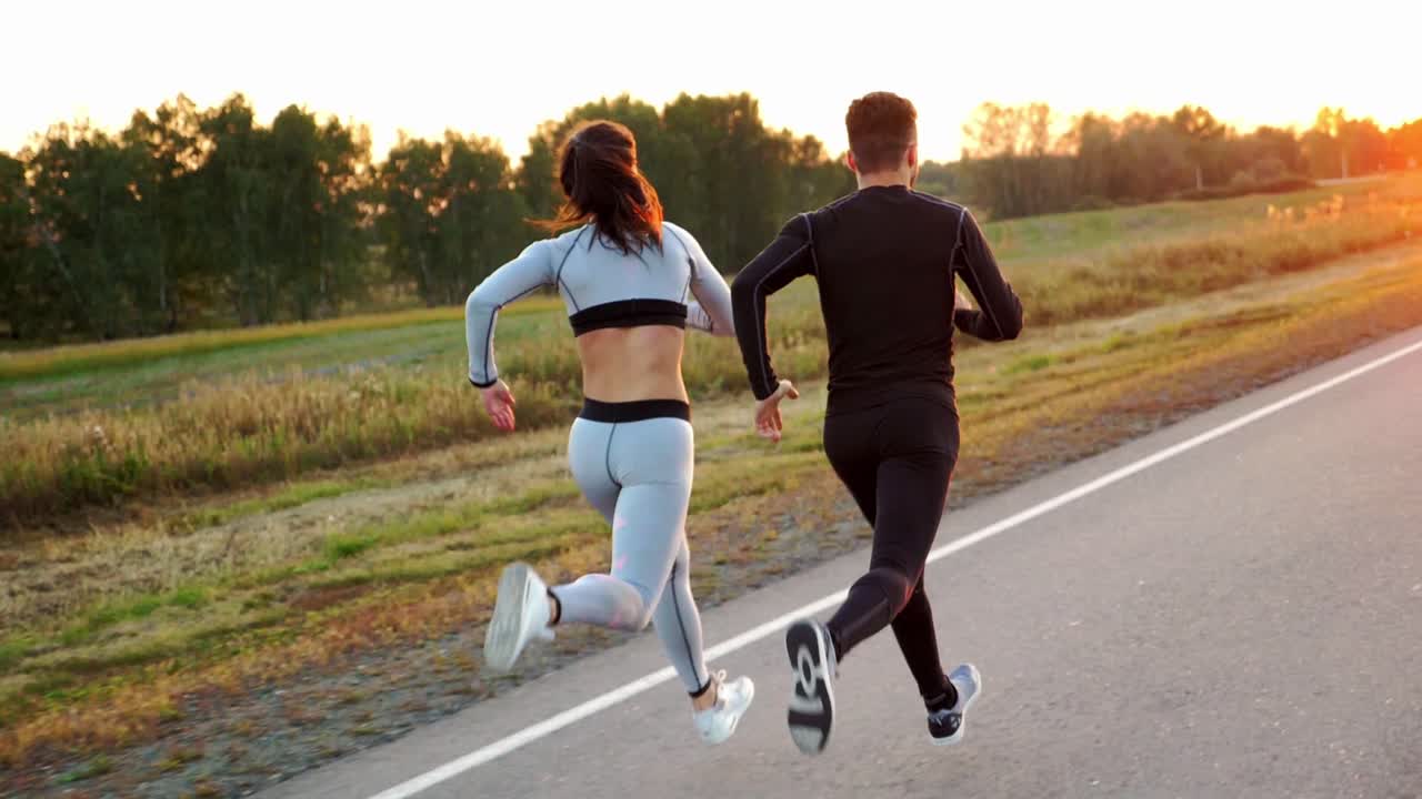Couple Running Outdoors at Sunset