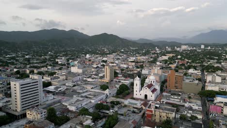 Aerial-Drone-Cityscape-Above-Santa-Marta-Colombia-Town-Cathedral-Andean-Mountain-Cordillera-Background,-Historic-Center