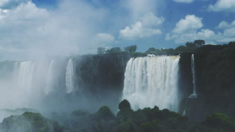 Iguazu-Falls-Waterfall-in-Brazil,-Dramatic-Distant-View-of-Beautiful-Waterfalls-in-Picturesque-Jungle-Greenery-Landscape,-Amazing-Water-Falling-off-Huge-Cliffs-in-Beautiful-Sunny-Conditions