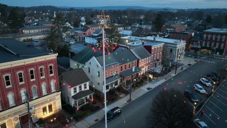 Forward-dolly-aerial-above-Christmas-lights-and-star-decorations-in-winter