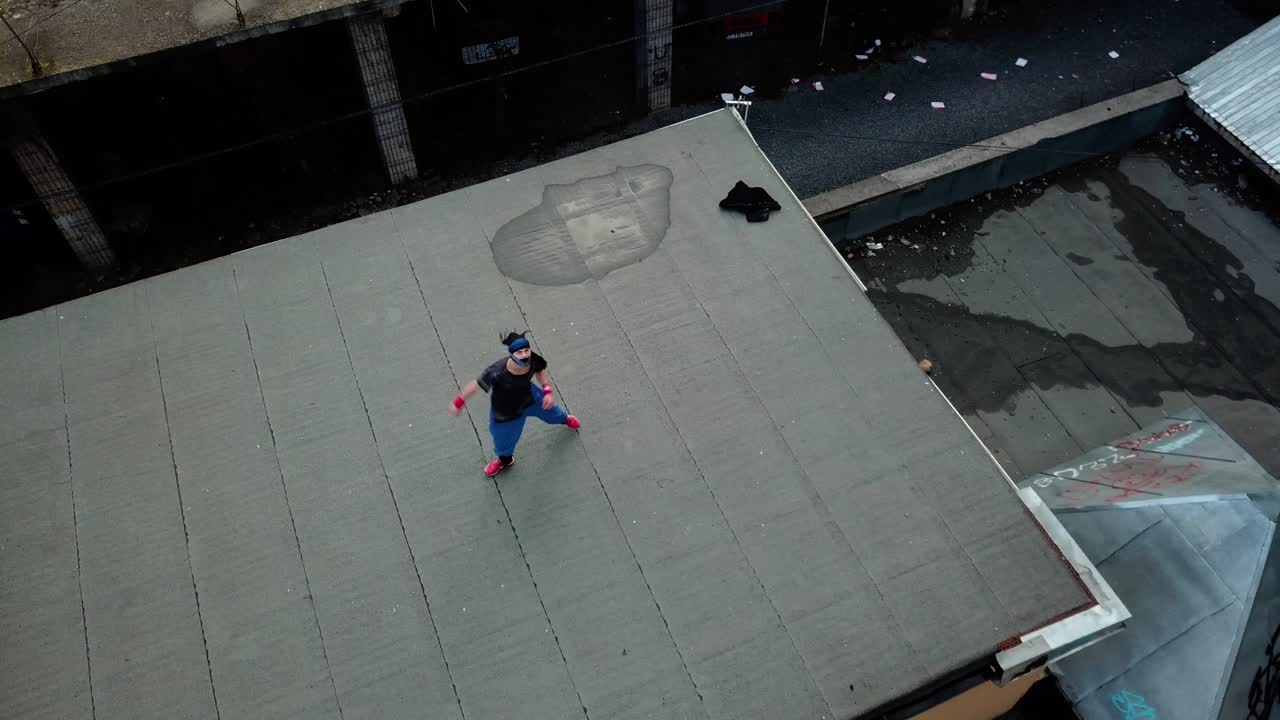 Overhead Aerial Drone Shot Of A Young Adult Male Parkour Free Runner  Practicing On An Abandoned Roof Top Free Stock Video Footage Download Clips