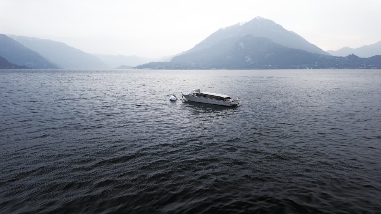 Isolated motorboat moored near the shore in Lake Como, Italy