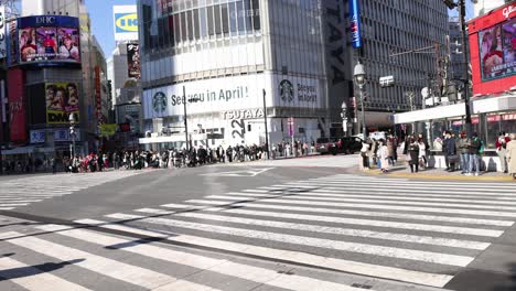 pedestrians crossing a busy urban intersection