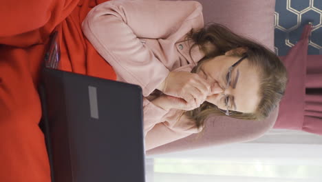 video vertical de la mujer está fría y tratando de usar una computadora portátil.