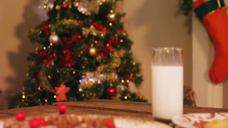 gingerbread cookies with a glass of milk on wooden table