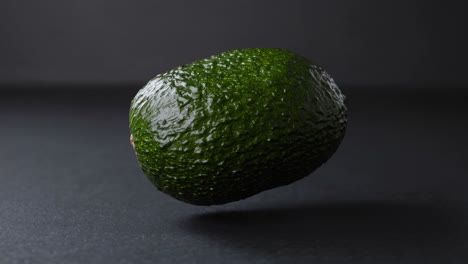 single avocado on dark background