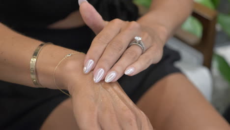 unrecognizable caucasian woman applies skin care lotion to own hand cu