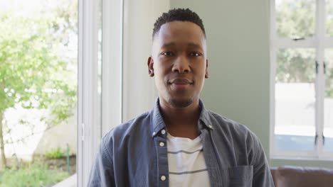 portrait of happy african american man smiling in living room