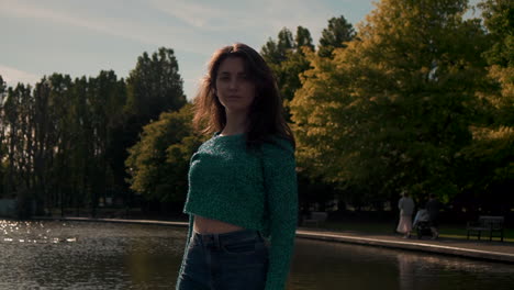 Gorgeous-Italian-fashion-model-posing-in-her-outfit-in-front-of-a-lake-in-London-at-golden-hour