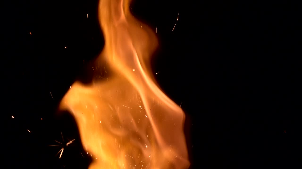 Burning hot bonfire fire sparks on a dark background. Fire sparks animation, slow motion