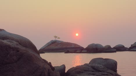 sunset over rocky coastline