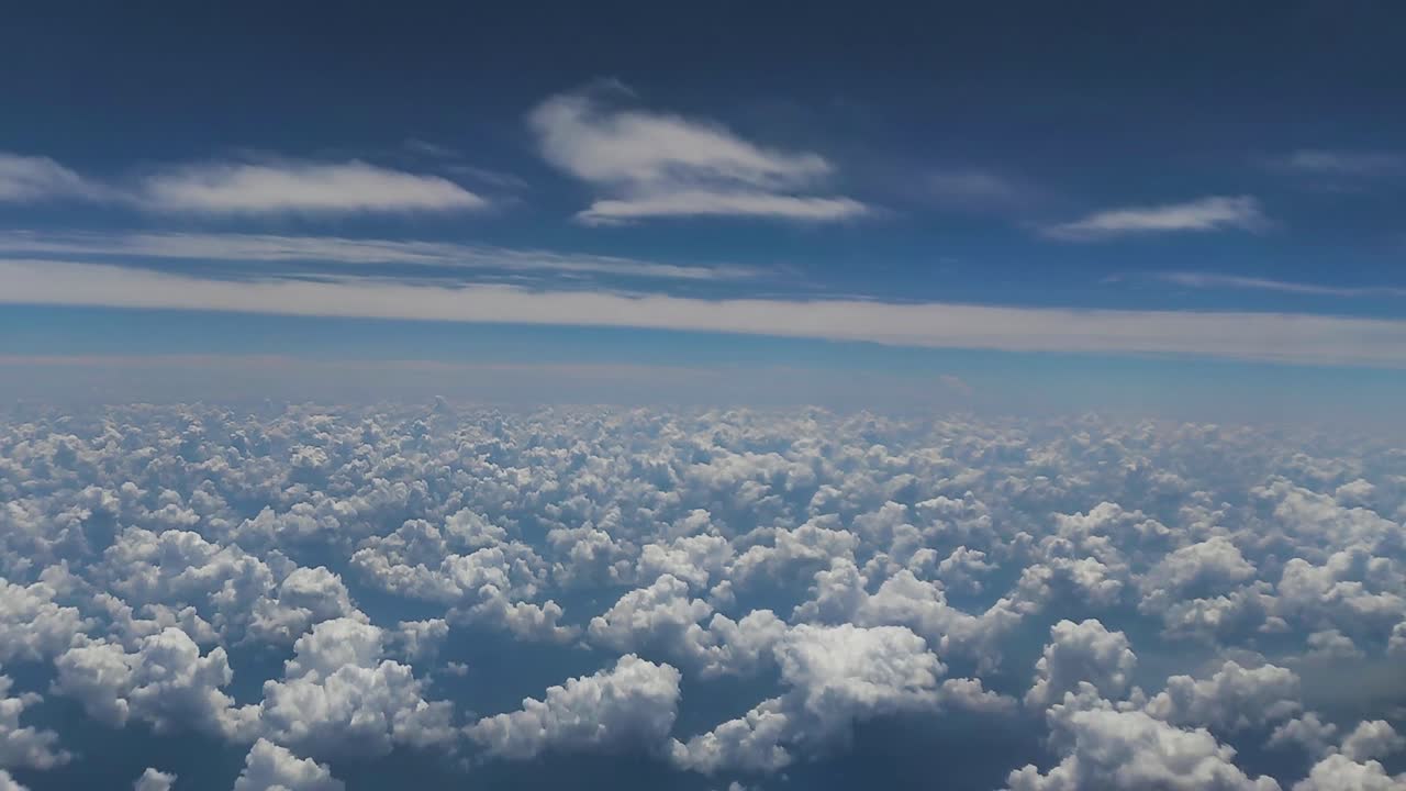 view of airplane cabin, white clouds and blue sky
