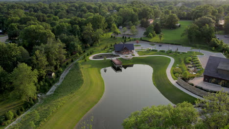 Aerial-pull-back-from-a-pretty-park-with-a-pond-in-Town-and-Country-in-St