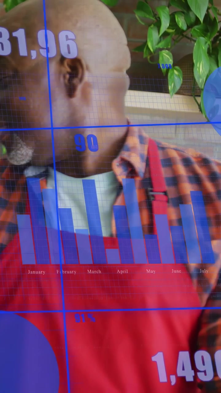 Vertical video: Senior cook in kitchen turning while data overlaying charts on apron to read data