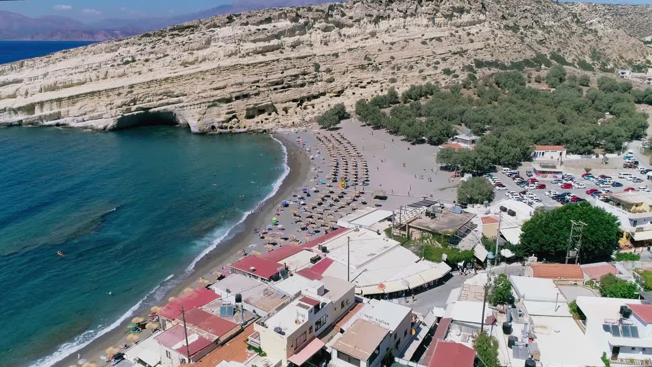 Beautiful view from a drone flying over the beach and bay in Matala Crete Greece