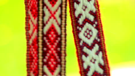 Red-ribbon-decoration-with-white-slavic-pattern.-Slavic-amulets-with-ornament