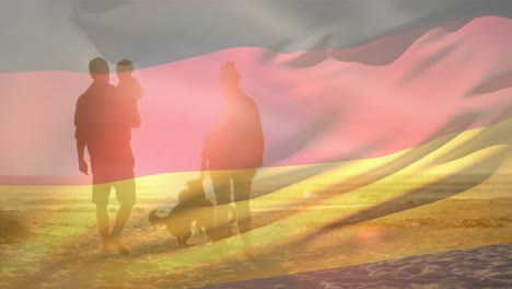 animation of flag of germany over caucasian parents with child and dogs at beach