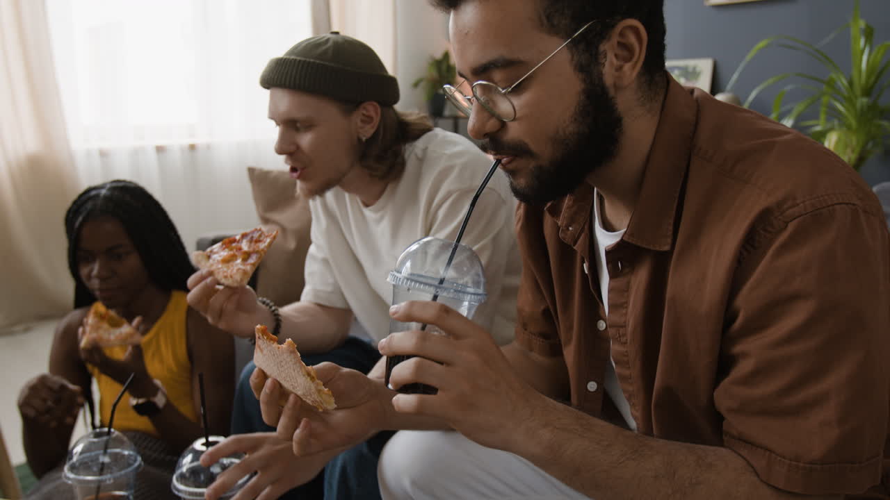 Friends Eating Pizza and Drinks at Home