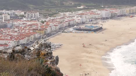 toma en cámara lenta del suburbio de la ciudad de nazare con tiendas de playa de arena y casas desde un acantilado en portugal europa 1920x1080 hd