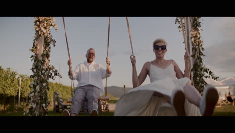 couple enjoying wedding swings