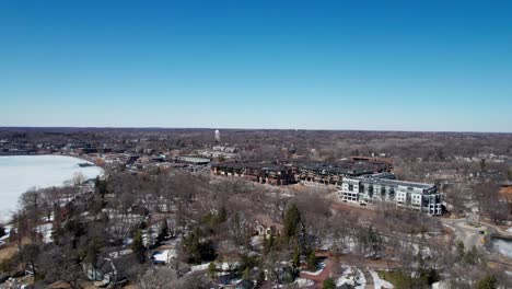 drone aerial view of downtown wayzata, minnesota condos and businesses