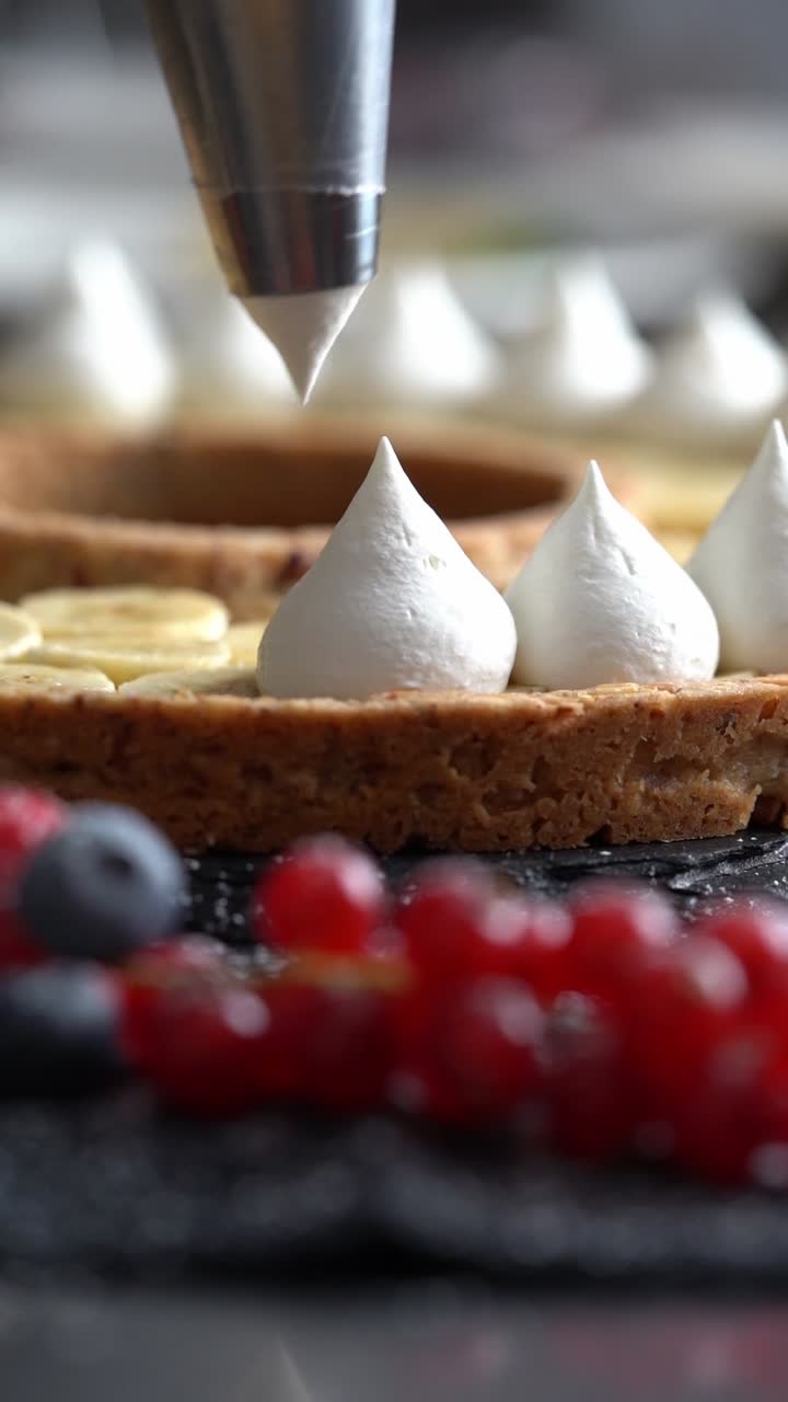 A skilled chef adding smooth cream to a delicious cake, close up shot, insert shot