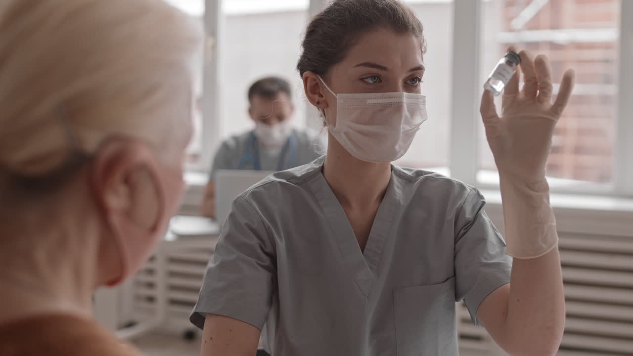 Female Doctor Looking at Ampoule